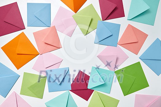Greeting cards of handcraft multicolored envelopes frame on a light background with copy space. Greeting cards of handcraft multicolored envelopes frame on a light background with copy space.
