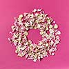 Creative background with round floral frame from carnation's petals on a purple, copy space. Flat lay.