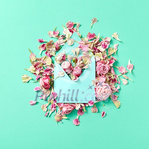 Congratulation composition of handmade envelope and pink roses flowers on a light turquoise background with copy space. Flat lay. Congratulation composition of handmade envelope and pink roses flowers on a light turquoise background with copy space. Flat lay.