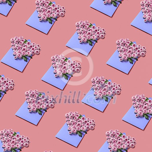 Flowers in the shape of hearts in the handmade envelopes on a pastel background. Creative greeting pattern. Flowers in the shape of hearts in the handmade envelopes on a pastel background. Creative greeting pattern.