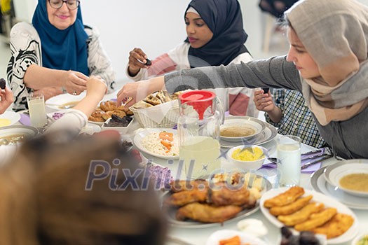 modern multiethnic muslim family enjoying eating iftar dinner together during a ramadan feast at home modern multiethnic muslim family enjoying eating iftar dinner together during a ramadan feast at home