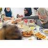 modern multiethnic muslim family enjoying eating iftar dinner together during a ramadan feast at home