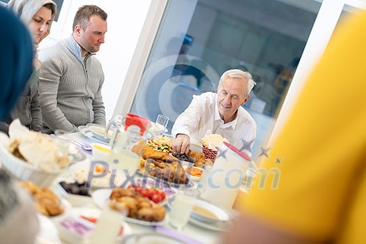 modern multiethnic muslim family enjoying eating iftar dinner together during a ramadan feast at home modern multiethnic muslim family enjoying eating iftar dinner together during a ramadan feast at home