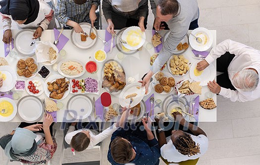 top view of modern multiethnic muslim family enjoying eating iftar dinner together during a ramadan feast at home top view of modern multiethnic muslim family enjoying eating iftar dinner together during a ramadan feast at home