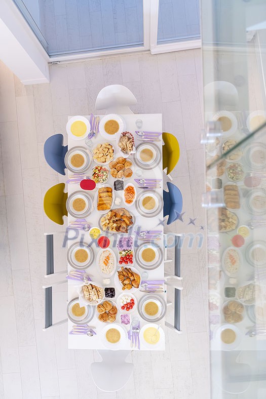 top view of beautiful decorated and served colorful food for iftar dinner on the white table during ramadan feast at home top view of beautiful decorated and served colorful food for iftar dinner on the white table during ramadan feast at home