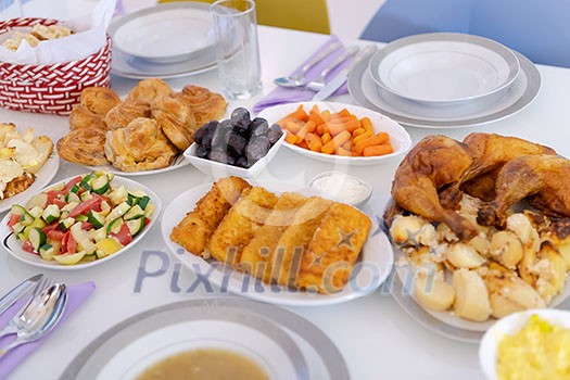 beautiful decorated and served colorful food for iftar dinner on the white table during ramadan feast at home beautiful decorated and served colorful food for iftar dinner on the white table during ramadan feast at home