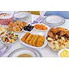 beautiful decorated and served colorful food for iftar dinner on the white table during ramadan feast at home