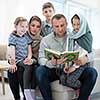 portrait of young happy modern muslim family before iftar dinner during ramadan feast at home