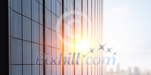 Modern business city building and rays of sunrise Modern business city building and rays of sunrise