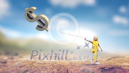 Cute kid girl outdoors with dollar sign on rope. Mixed media Cute kid girl outdoors with dollar sign on rope. Mixed media