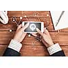 Top view of woman sitting at table and using smartphone