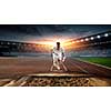 Athlete man running on racetrack at stadium. Mixed media