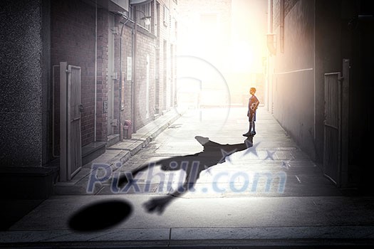 Kid boy with ball and his shadow on wall. Mixed media Kid boy with ball and his shadow on wall. Mixed media