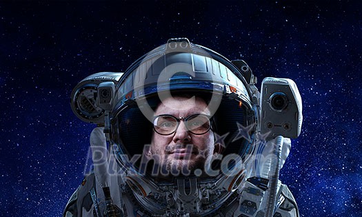Astronaut man on space mission with starry sky on the background. Mixed media Astronaut man on space mission with starry sky on the background. Mixed media