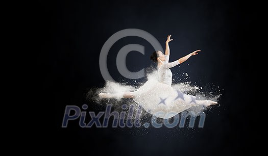 Elegant woman dancer in white dress against dark background Elegant woman dancer in white dress against dark background