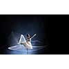 Elegant woman dancer in white dress against dark background