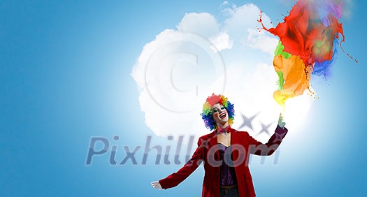 Woman with clown make up wearing wig and color paint splashes . Mixed media Woman with clown make up wearing wig and color paint splashes . Mixed media