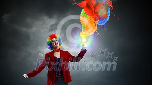 Woman with clown make up wearing wig and color paint splashes . Mixed media Woman with clown make up wearing wig and color paint splashes . Mixed media