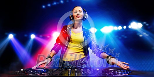 Young attractive woman dj in playing her music. Mixed media Young attractive woman dj in playing her music. Mixed media
