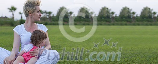 Young Mother and cute little daughter enjoying free time playing outside at backyard on the grass, happy family in nature concept Young Mother and cute little daughter enjoying free time playing outside at backyard on the grass, happy family in nature concept