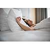 Beautiful young woman sleeping on bed at bedroom