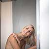 Woman taking a long hot shower in a modern design bathroom
