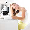 Teenage girl studing for school, doing homework on a sunny Sunday morning in a lovely, bright room
