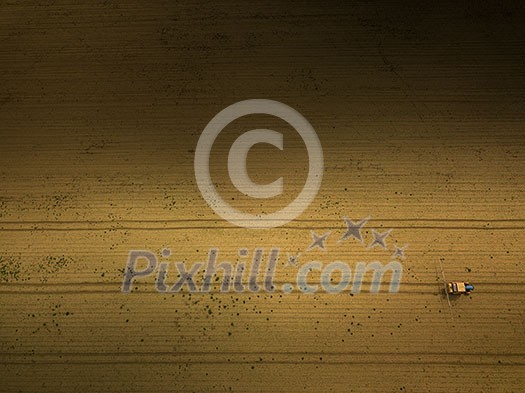 Tractor spraying crops in field, aerial view from drone pov Tractor spraying crops in field, aerial view from drone pov