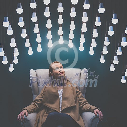 Pretty, young woman having so many ideas for business ventures - light bulb illumination/eureka moment concept image (color toned image) Pretty, young woman having so many ideas for business ventures - light bulb illumination/eureka moment concept image (color toned image)