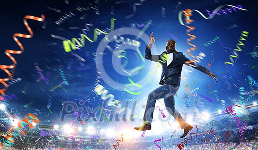 Afroamerican man running on stadium track. Mixed media Afroamerican man running on stadium track. Mixed media
