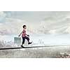 Cute little boy walking on rope high in sky
