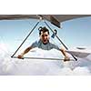 Brave hang glider pilot soaring high in sky. Mixed media