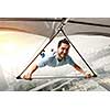Brave hang glider pilot soaring high in sky. Mixed media