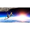 Selfie shot of brave hang glider pilot soaring with book in hands. Mixed media