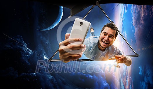 Selfie shot of brave hang glider pilot soaring in space. Mixed media Selfie shot of brave hang glider pilot soaring in space. Mixed media