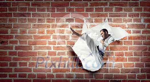 Angry karate man torn white paper. Mixed media Angry karate man torn white paper. Mixed media
