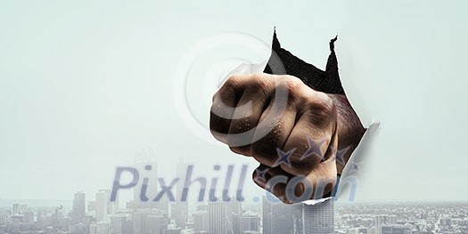 Boxer man making punch and break through white paper. Mixed media Boxer man making punch and break through white paper. Mixed media