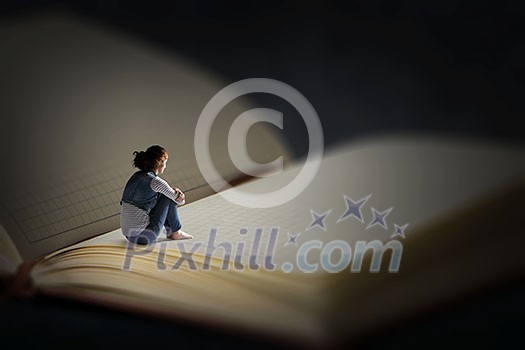 Woman sitting on pages of huge book. Mixed media Woman sitting on pages of huge book. Mixed media