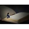 Woman sitting on pages of huge book. Mixed media