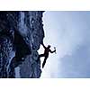 Young man climber hanging on slope cliff. Mixed mefia