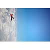 Alpinist man climbing white cloud high in sky. Mixed media