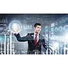 Portrait of businessman working with virtual panel interface. Mixed media