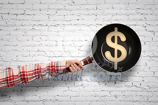 Close of woman hand holding pan against concrete background. Mixed media Close of woman hand holding pan against concrete background. Mixed media