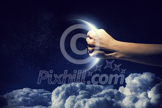 Human hand catching moon planet in palm Human hand catching moon planet in palm
