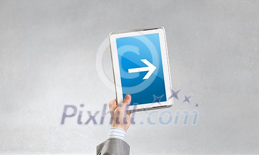 Close of businessman hand holding tablet with arrow on screen Close of businessman hand holding tablet with arrow on screen