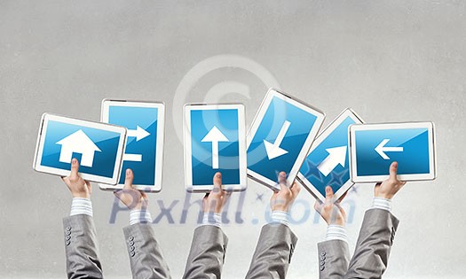 Close of businessman hands holding tablet with arrow on screen Close of businessman hands holding tablet with arrow on screen