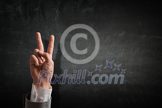 Close of businessman hand showing peace gesture . Close of businessman hand showing peace gesture .
