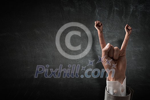 Close of businessman hand showing rock gesture . Close of businessman hand showing rock gesture .