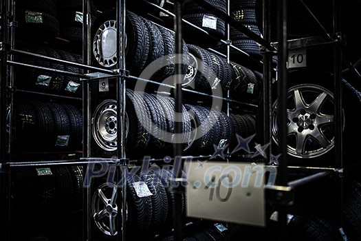 Tyres being stored in a garage - waiting for the client to have them put on his car Tyres being stored in a garage - waiting for the client to have them put on his car