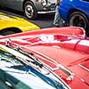 Old cars auction - People viewing cars on sale during an expensive old cars  auction